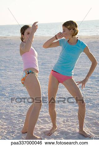 Two preteen girls dancing on beach View Large Photo Image Stock Photograph - Two preteen girls dancing on beach. Fotosearch