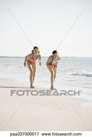 Two preteen girls ready to race on beach View Large Photo Image Stock Photo - Two preteen girls ready to race on beach. Fotosearch