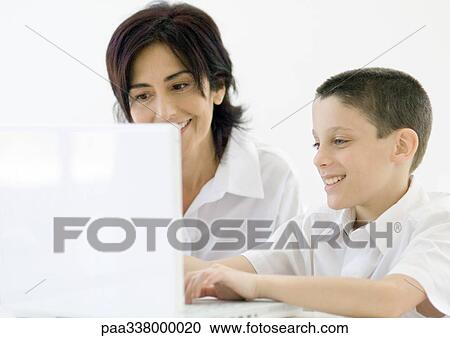 Boy and grandmother using laptop View Large Photo Image Stock Image - Boy and grandmother using laptop. Fotosearch