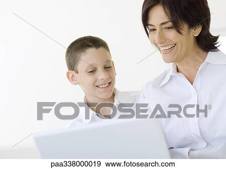 Stock Photo - Boy and grandmother using laptop. Fotosearch