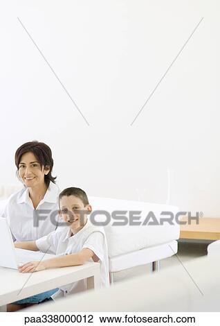 Boy and mature woman using laptop View Large Photo Image Stock Image - Boy and mature woman using laptop. Fotosearch