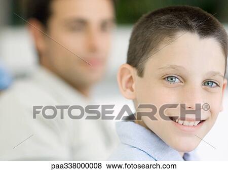 Boy, portrait with father in background View Large Photo Image Stock Photo - Boy, portrait with father in background. Fotosearch