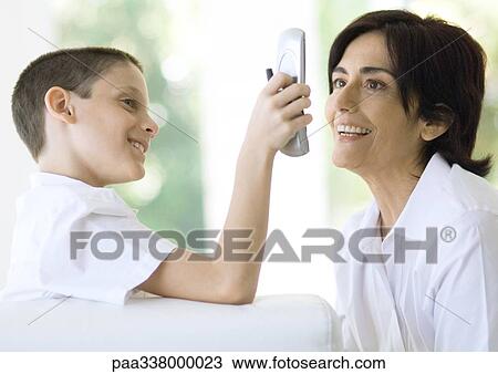 Boy showing grandmother cell phone View Large Photo Image Stock Image - Boy showing grandmother cell phone. Fotosearch