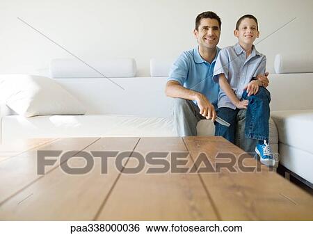 Father and son watching tv View Large Photo Image Stock Photograph - Father and son watching tv. Fotosearch