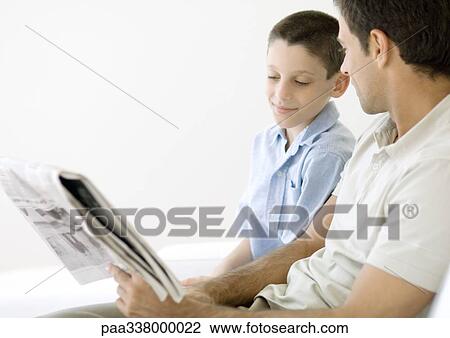 Man and son looking at newspaper together View Large Photo Image Stock Image - Man and son looking at newspaper together. Fotosearch