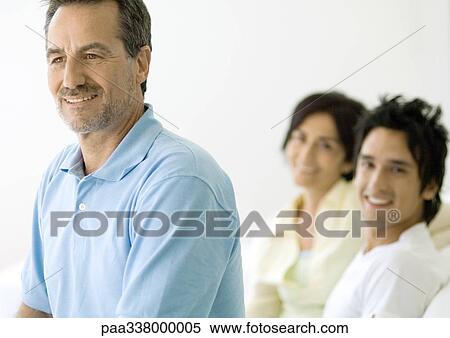 Mature man, wife and adult son in background View Large Photo Image Stock Photography - Mature man, wife and adult son in background. Fotosearch