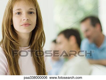 Preteen girl, family in background View Large Photo Image Stock Photograph - Preteen girl, family in background. Fotosearch