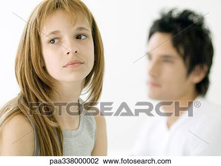 Preteen girl looking away, older brother in background View Large Photo Image Stock Image - Preteen girl looking away, older brother in background. Fotosearch