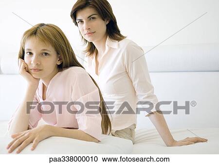 Preteen girl with mother in background View Large Photo Image Stock Image - Preteen girl with mother in background. Fotosearch