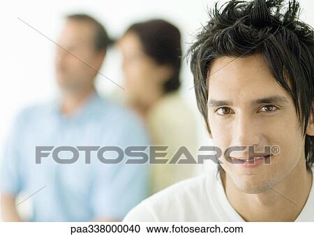 Young man, parents in background View Large Photo Image Stock Image - Young man, parents in background. Fotosearch
