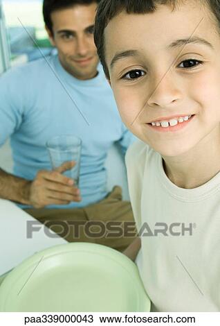 Boy and father with dishes View Large Photo Image Stock Image - Boy and father with dishes. Fotosearch
