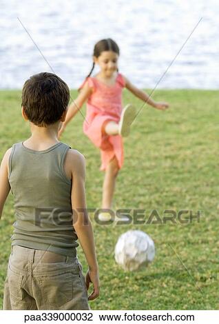 Boy and girl playing soccer View Large Photo Image Stock Image - Boy and girl playing soccer. Fotosearch