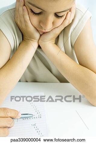 Boy doing homework with father's help, cropped View Large Photo Image Picture - Boy doing homework with father's help, cropped. Fotosearch