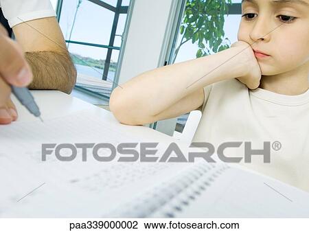 Boy doing homework with father's help, cropped View Large Photo Image Stock Image - Boy doing homework with father's help, cropped. Fotosearch