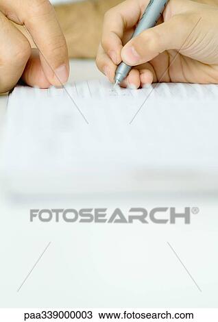 Stock Image - Boy doing homework with father's help, cropped. Fotosearch