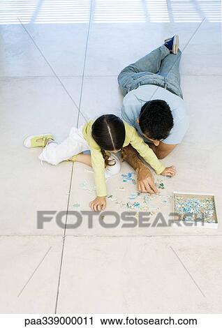 Father and daughter putting together puzzle View Large Photo Image Stock Image - Father and daughter putting together puzzle. Fotosearch