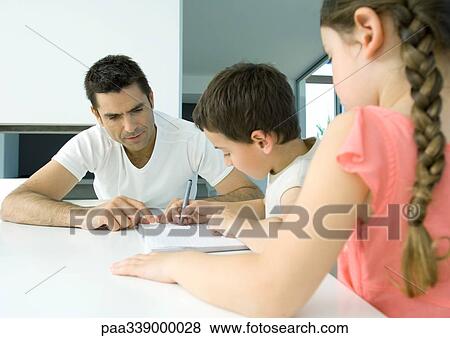 Father helping children with homework View Large Photo Image Stock Photo - Father helping children with homework. Fotosearch