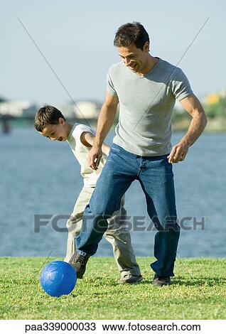 Man and son playing soccer View Large Photo Image Stock Image - Man and son playing soccer. Fotosearch