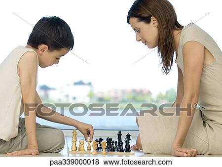 Stock Photo - Mother and son playing chess. Fotosearch