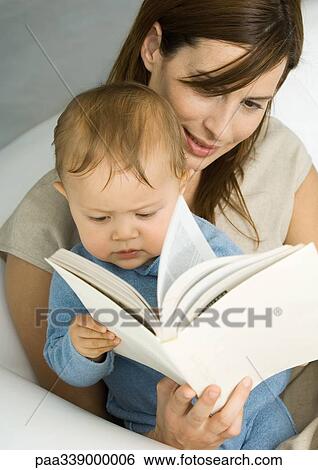 Stock Photograph - Mother reading book to baby. Fotosearch