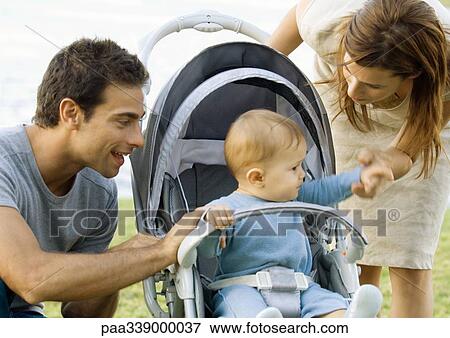 Young couple with baby in stroller View Large Photo Image Stock Photo - Young couple with baby in stroller. Fotosearch