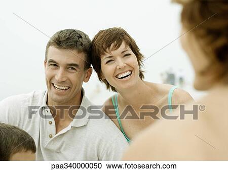 Couple smiling on beach View Large Photo Image Stock Image - Couple smiling on beach. Fotosearch