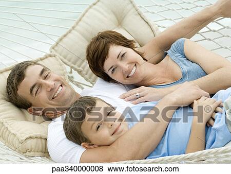 Family lying in hammock, smiling View Large Photo Image Stock Photo - Family lying in hammock, smiling. Fotosearch