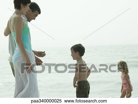 Stock Photography - Family on beach. Fotosearch