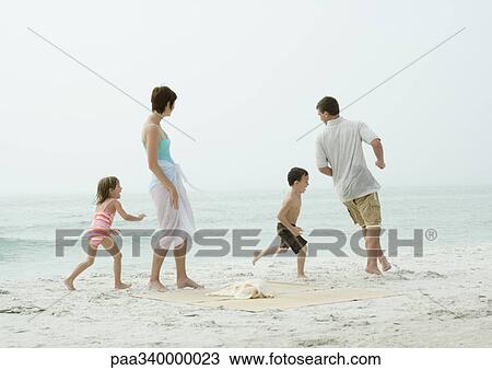 Family playing around on beach View Large Photo Image Stock Image - Family playing around on beach. Fotosearch