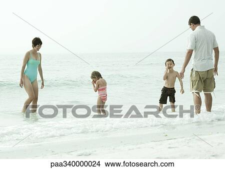 Family playing in surf View Large Photo Image Picture - Family playing in surf. Fotosearch