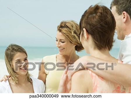Friends talking on beach View Large Photo Image Stock Photo - Friends talking on beach. Fotosearch
