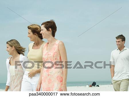 Group walking on beach View Large Photo Image Stock Photo - Group walking on beach. Fotosearch