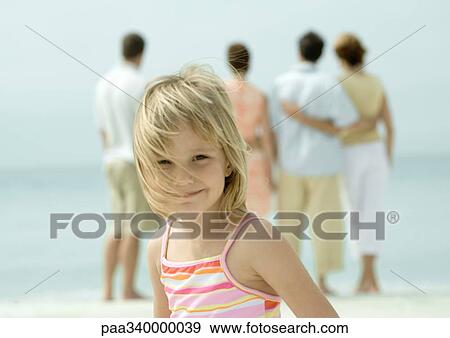 Little girl smiling, group looking at view in background View Large Photo Image Stock Photo - Little girl smiling, group looking at view in background. Fotosearch