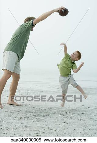 Man playing ball with son on beach View Large Photo Image Stock Photography - Man playing ball with son on beach. Fotosearch