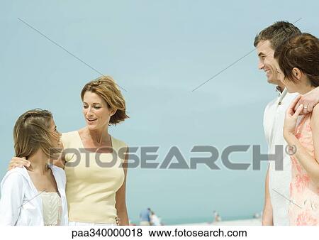 Mother and teenage daughter talking to couple on beach View Large Photo Image Stock Photo - Mother and teenage daughter talking to couple on beach. Fotosearch