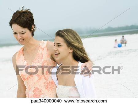 Woman walking with teenage daughter on beach View Large Photo Image Stock Image - Woman walking with teenage daughter on beach. Fotosearch