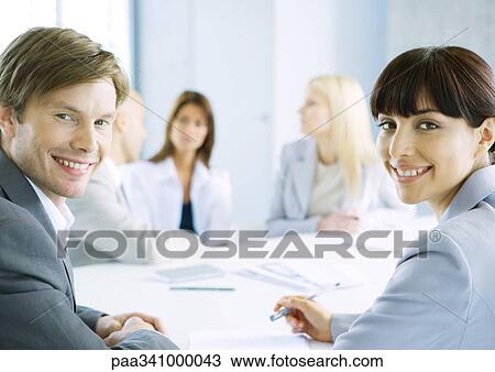 Business meeting, man and woman smiling at camera View Large Photo Image Stock Image - Business meeting, man and woman smiling at camera. Fotosearch