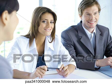 Business meeting, woman smiling at camera View Large Photo Image Stock Photo - Business meeting, woman smiling at camera. Fotosearch
