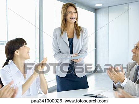 Business team applauding businesswoman View Large Photo Image Stock Photograph - Business team applauding businesswoman. Fotosearch