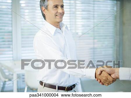 Businessman shaking hands View Large Photo Image Picture - Businessman shaking hands. Fotosearch