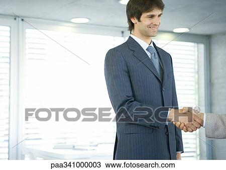 Stock Image - Businessman shaking hands. Fotosearch