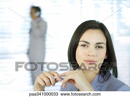 Stock Image - Businesswoman smiling at camera, portrait. Fotosearch