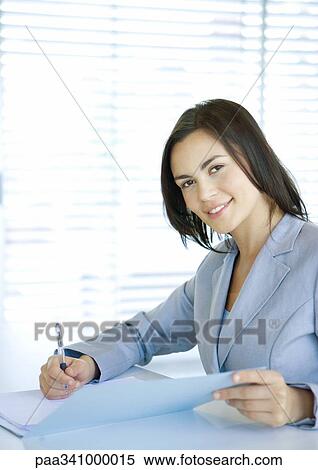 Businesswoman smiling at camera, portrait View Large Photo Image Stock Photography - Businesswoman smiling at camera, portrait. Fotosearch