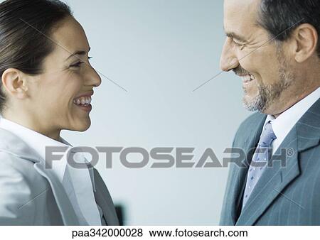 Business colleagues smiling at each other View Large Photo Image Stock Photo - Business colleagues smiling at each other. Fotosearch