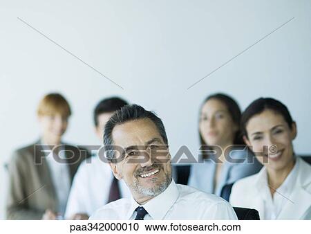 Stock Image - Business colleagues, smiling. Fotosearch