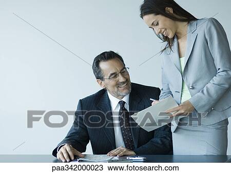 Business colleagues working together, smiling View Large Photo Image Stock Image - Business colleagues working together, smiling. Fotosearch