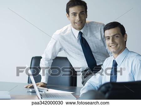 Business colleagues working together, smiling at camera View Large Photo Image Stock Image - Business colleagues working together, smiling at camera. Fotosearch