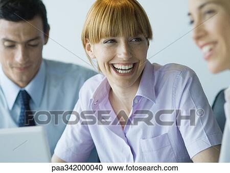 Business colleagues working together, smiling View Large Photo Image Stock Image - Business colleagues working together, smiling. Fotosearch