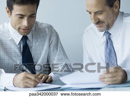 Stock Photo - Business colleagues working together. Fotosearch