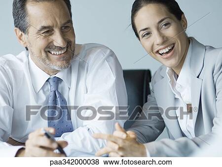 Business colleagues working together, smiling View Large Photo Image Stock Photo - Business colleagues working together, smiling. Fotosearch